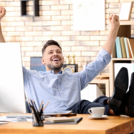 happy-working-man-at-desk