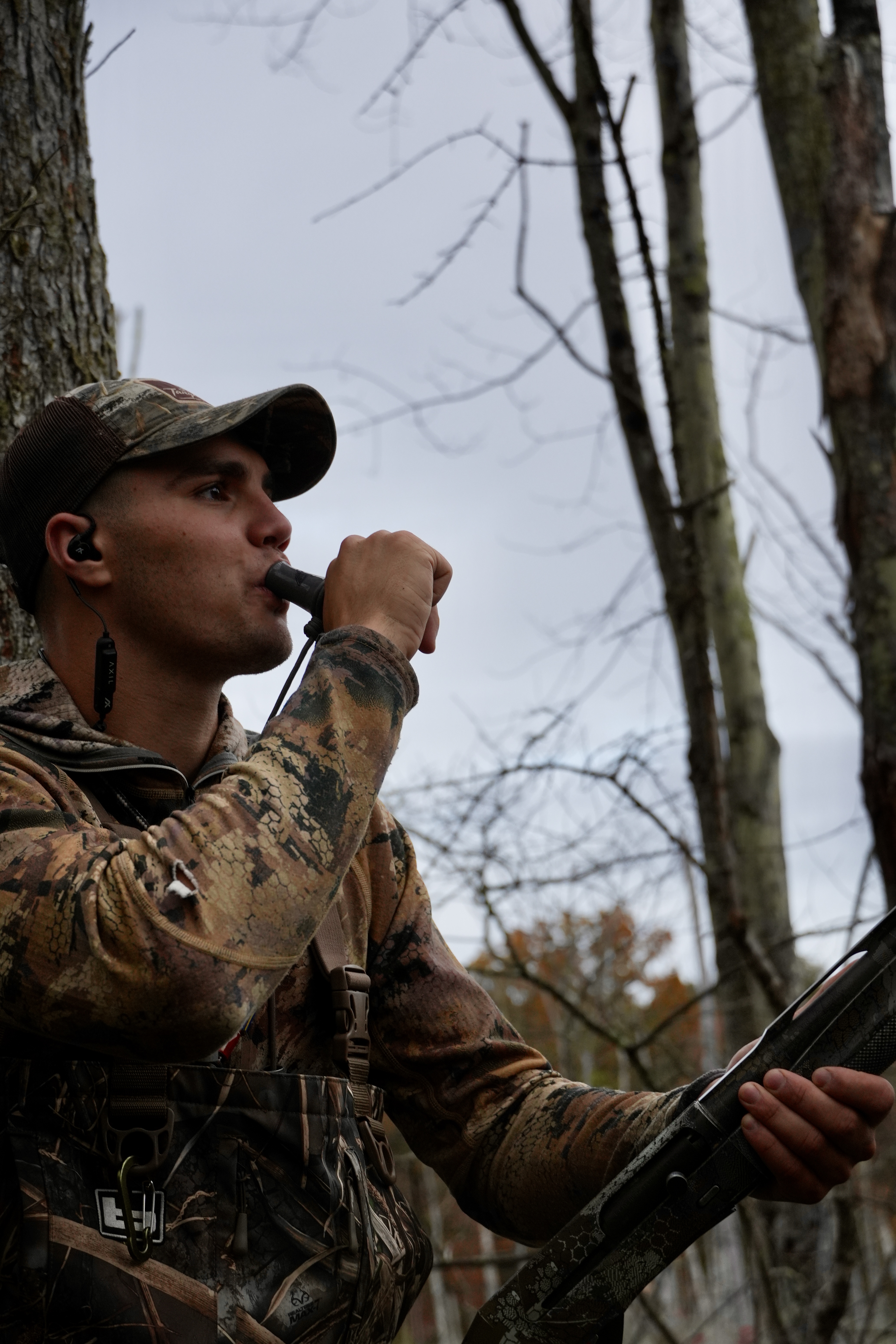 four people watching on white MacBook on top of glass-top table