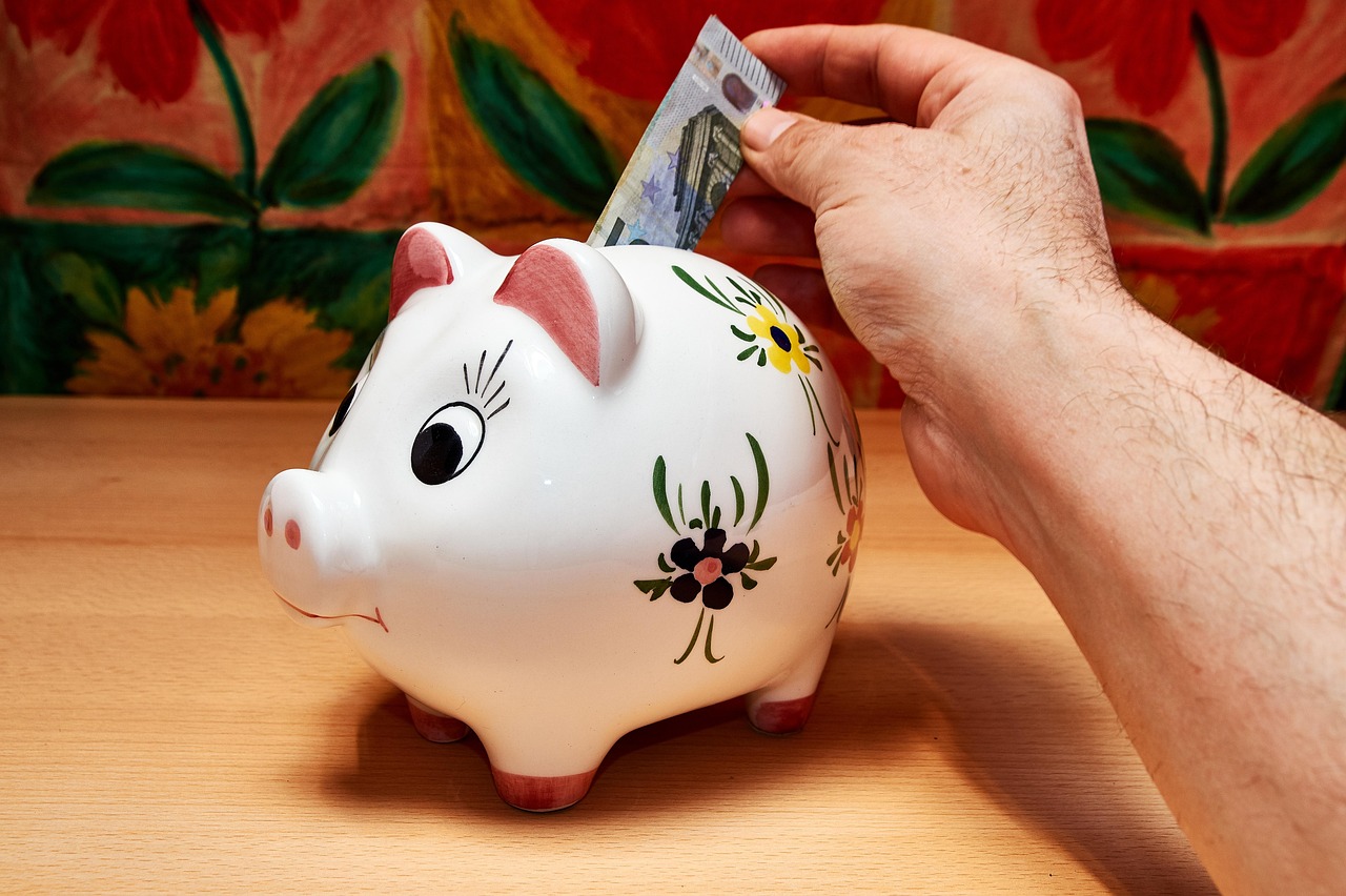 putting money into a piggy bank