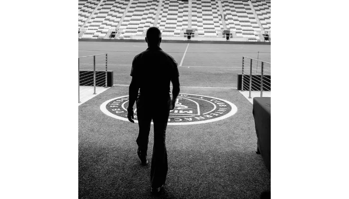 Marc Effron walking onto a field.