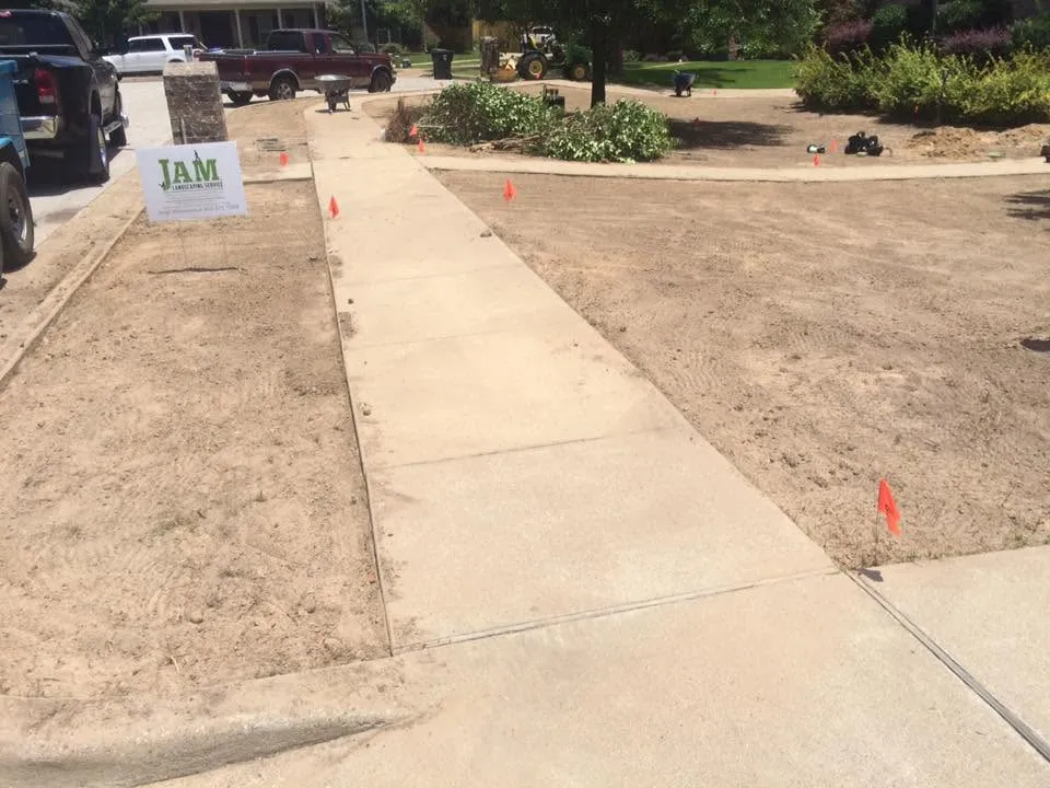 Yard graded and flagged before new sod at a JAM Tyler Landscape job site