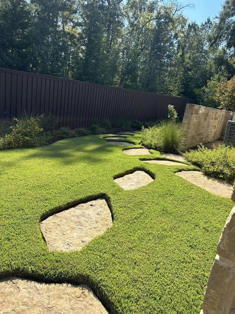 Flagstone stepping stone path set into new sod in a fenced Tyler TX back yard