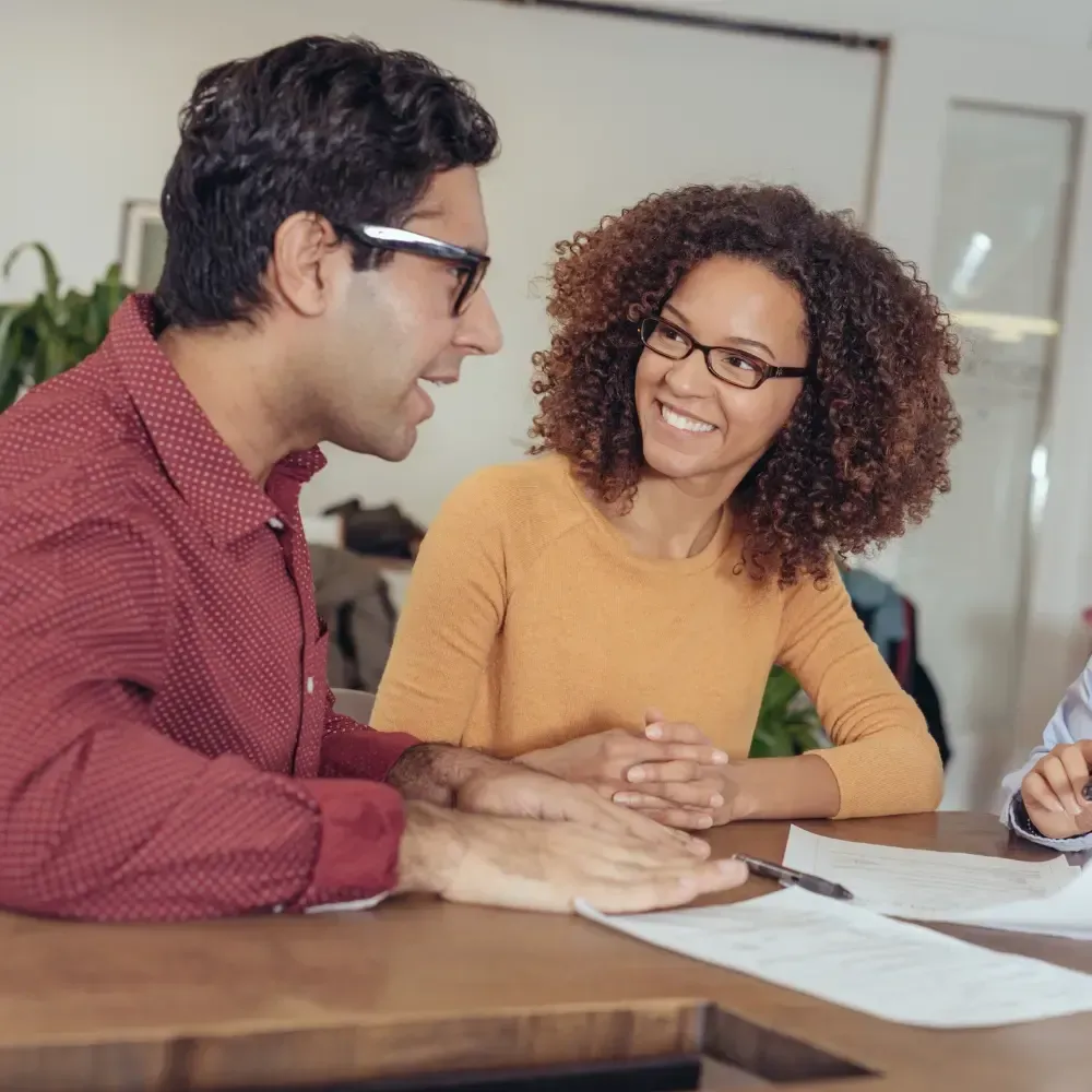 Landscape photo of a completed community water system with new storage tank and locals gathered nearby; bright daylight, clean engineering detail to illustrate a full sponsored project outcome for BlueHarbor Foundation.