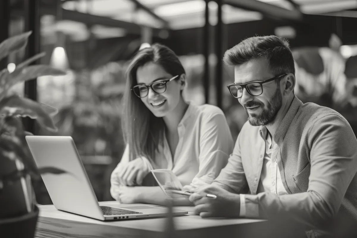 a lady and a man working together happily as  a financial advisor for business consulting