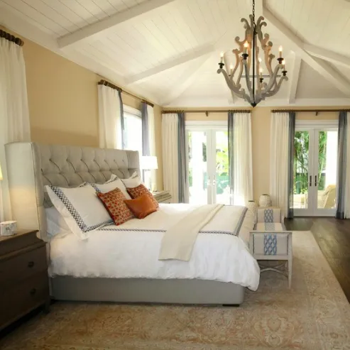 Spotless master bedroom with ornate light fixture