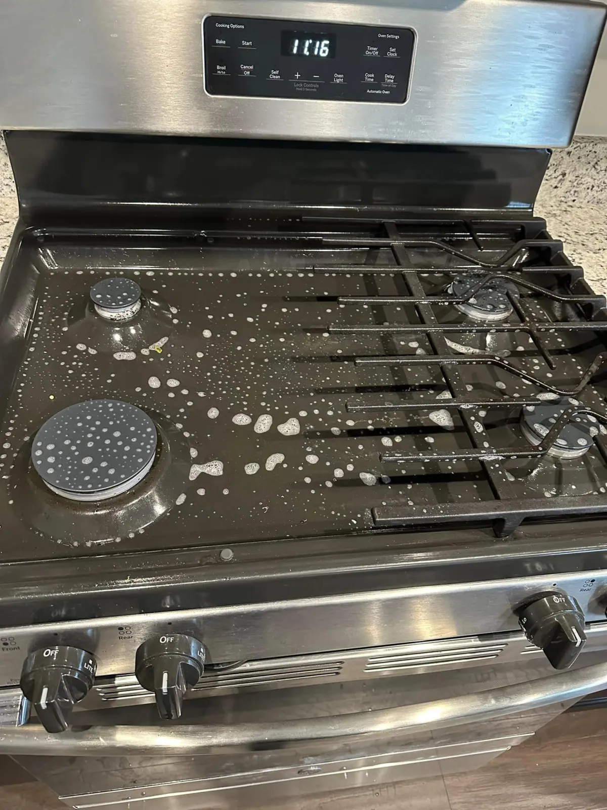 Stove top being meticulously cleaned from Grace's Cleaning Services Deep Cleaning Service.