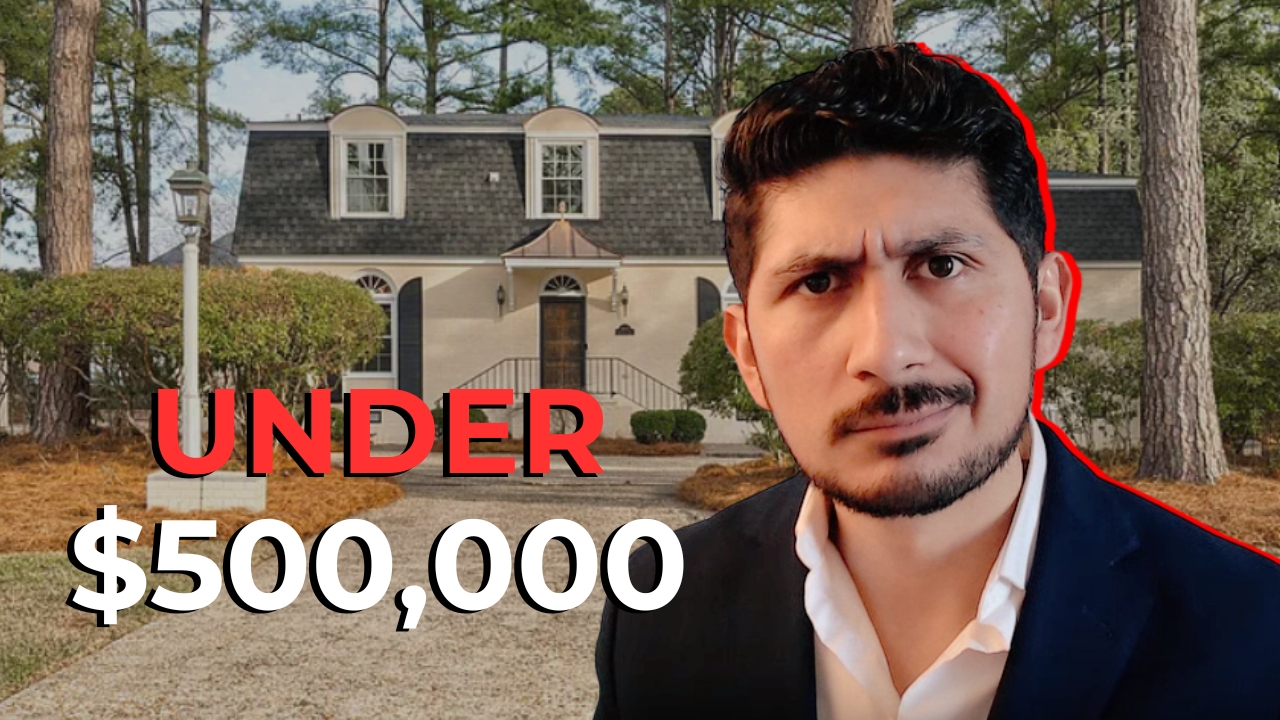 a living room filled with furniture and a kitchen