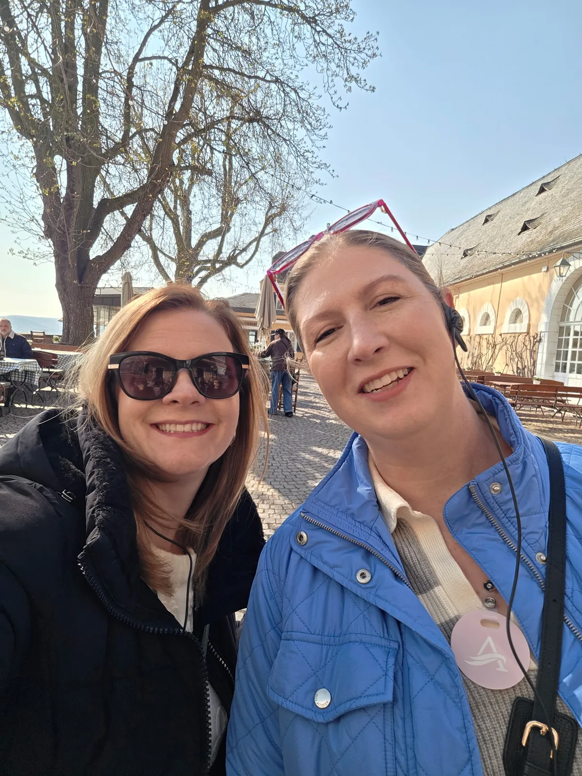 Two women smiling in front of the main tasting room at Schloss Johannesburg in Germany's Rhineland.