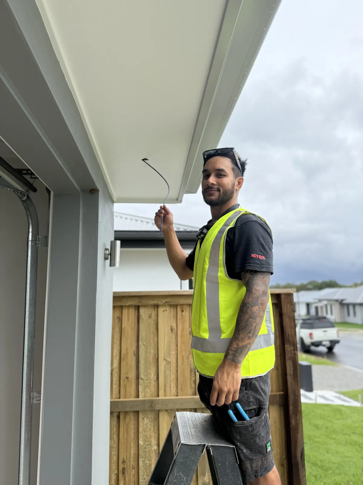 The man is installing a security camera in Australia