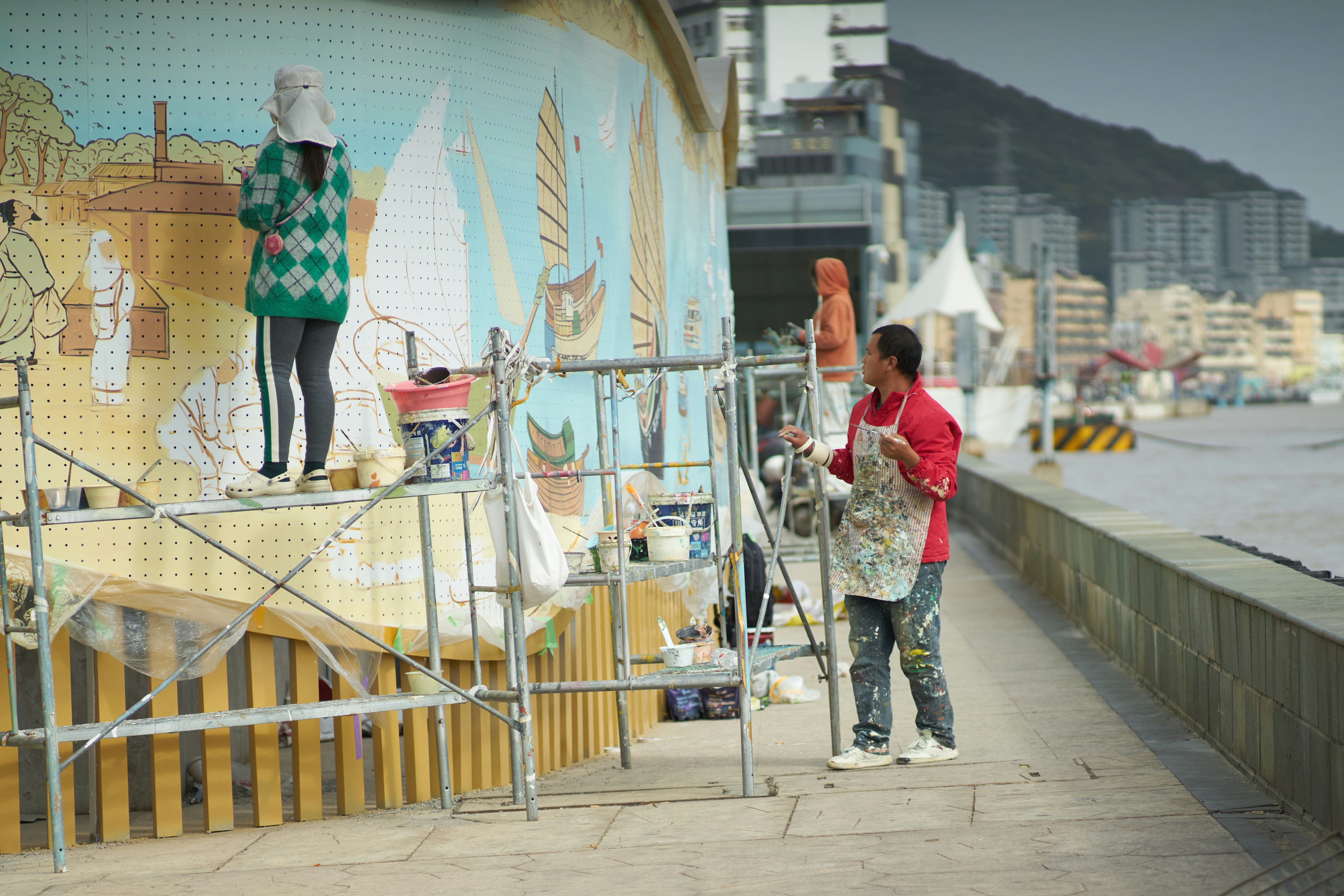 painters painting wall mural with lots of styles