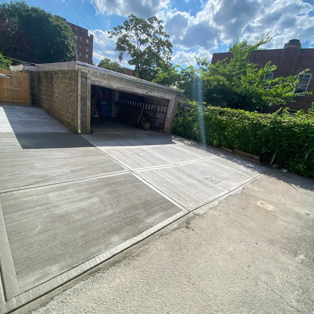 Remodeled concrete driveway and sidewalk in Queens, New York.