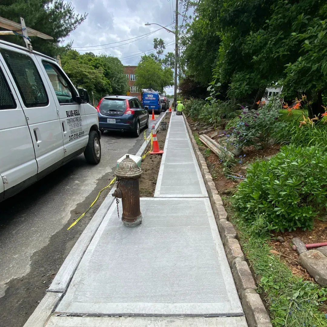 New concrete sidewalk with fire hydrant in Queens, New York.