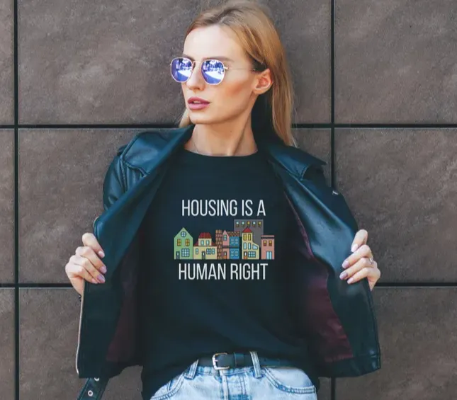 A diverse group of smiling people wearing Teesandhoodies4healing apparel, standing together outdoors, radiating warmth and unity.