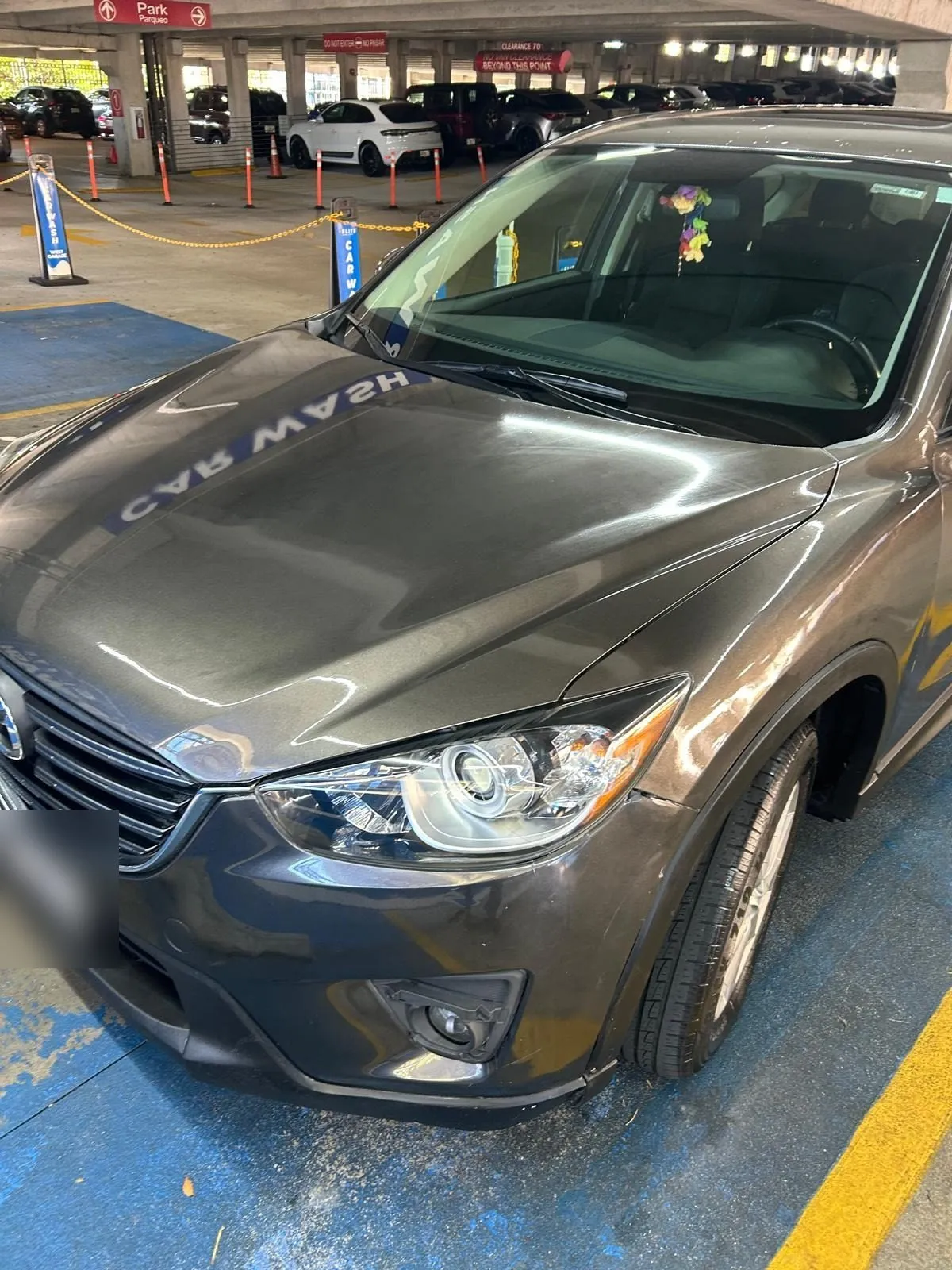 The same Mazda after, with a clean reflective hood in the MarMax bay