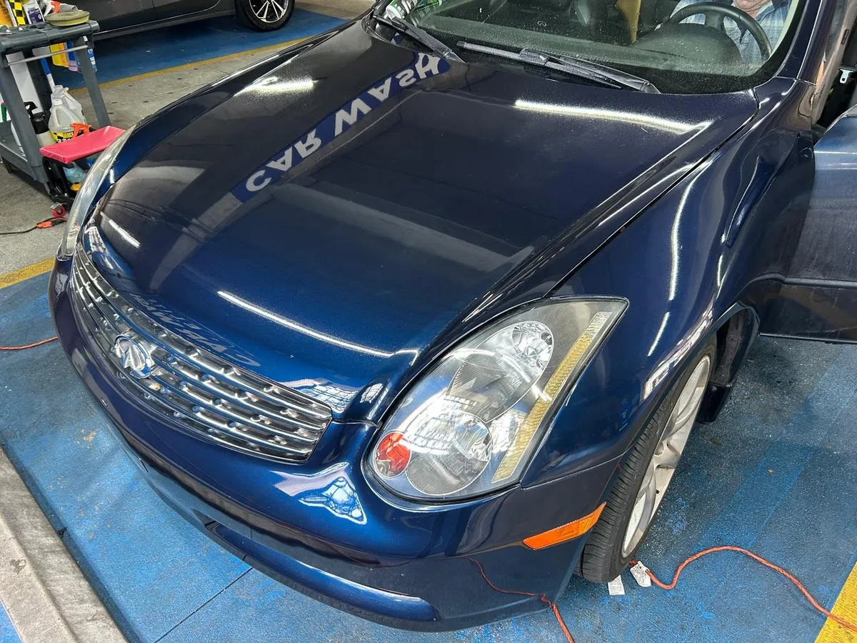 The same Infiniti after detailing, with clear headlights and glossy paint