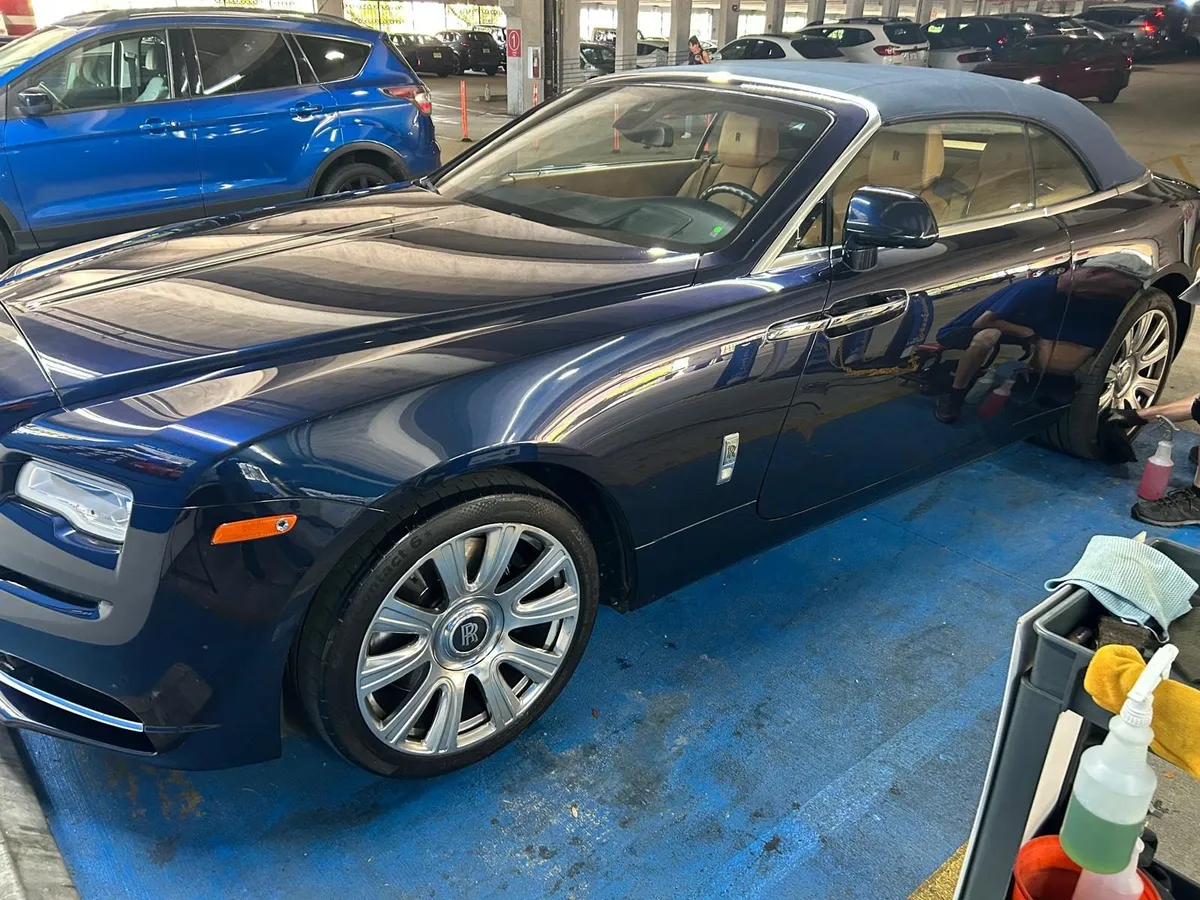 Navy Rolls-Royce convertible after a hand wash