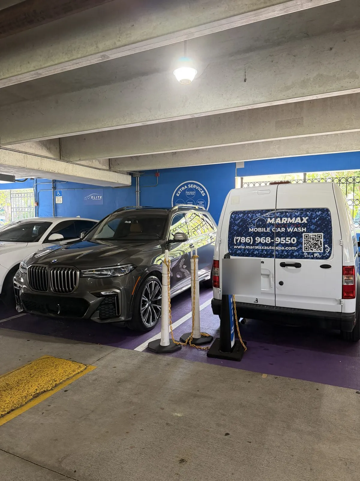 BMW X7 beside the MarMax mobile car wash van