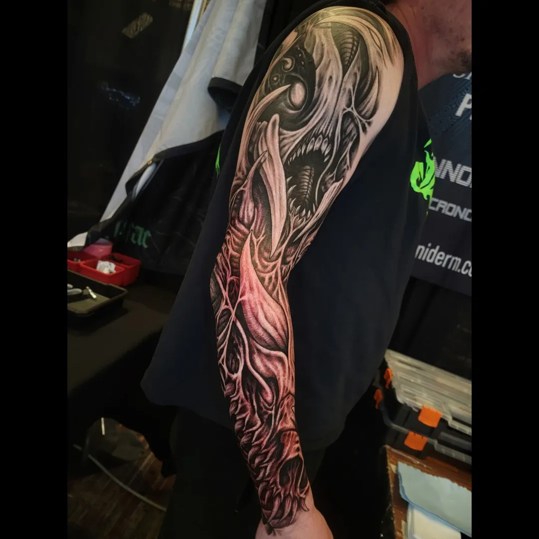Black and grey tattoo sleeve by Symbolic Body Art