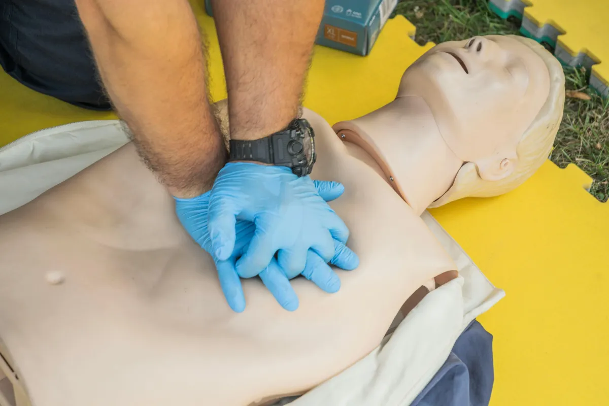 Someone practicing CPR on a dummy.