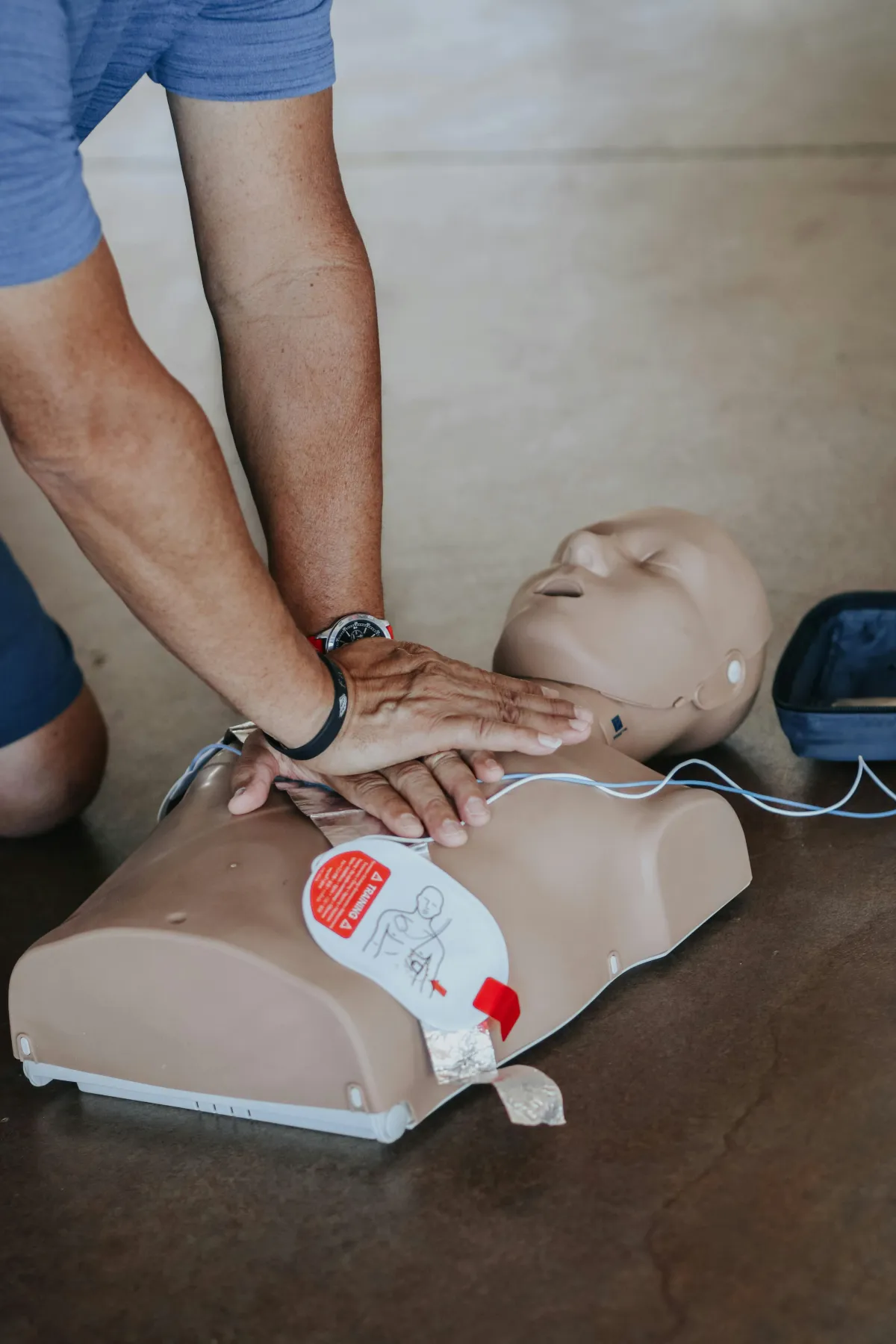 A person performing CPR on a dummy.