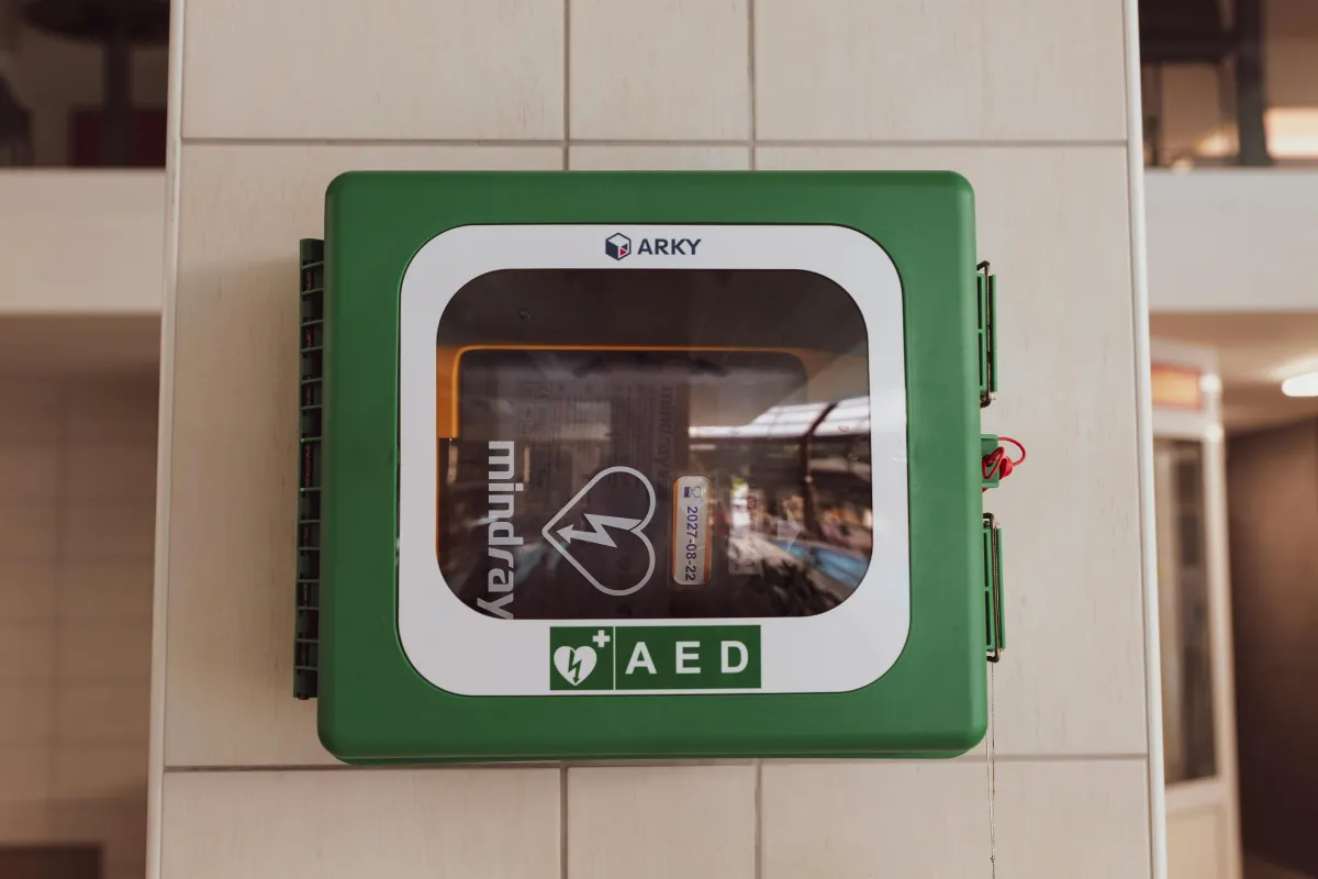 Someone using an AED on a paitient.
