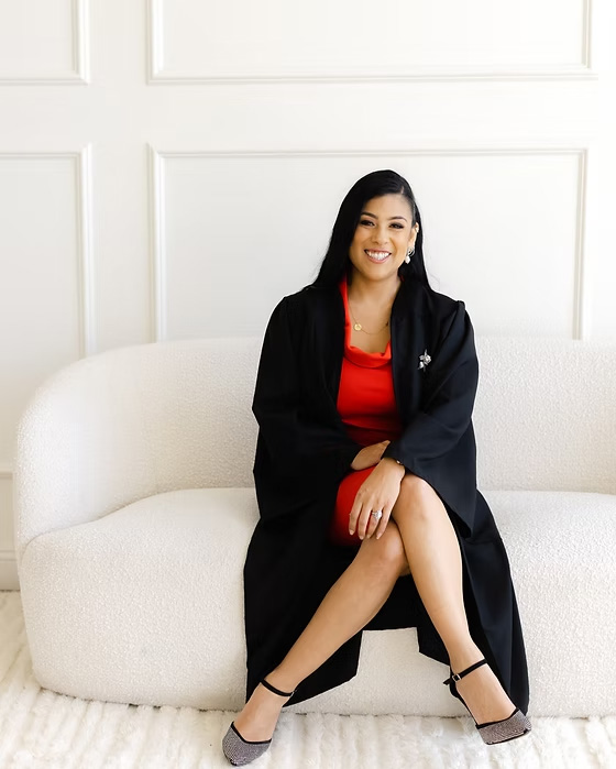 Wedding officiant Maricela smiling and holding a ceremony book in a light, airy chapel