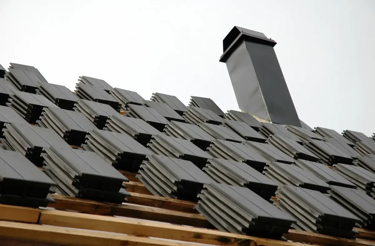Roofing contractor repairing damaged shingles and restoring a residential roof in Lynn, Massachusetts.