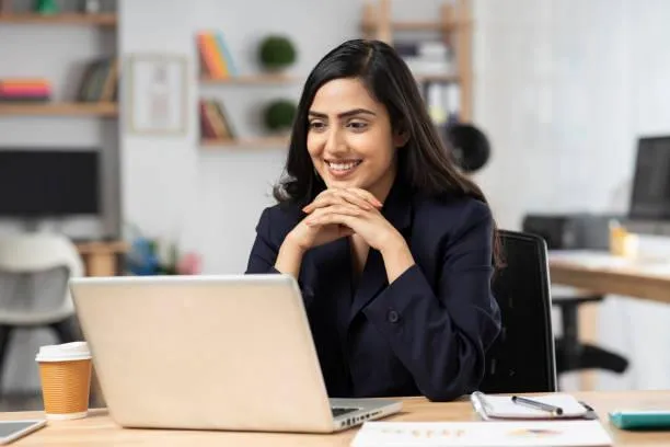 Woman wearing glasses smiling in an office setting