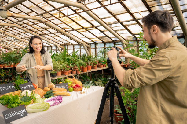 woman filming in her greenhouse