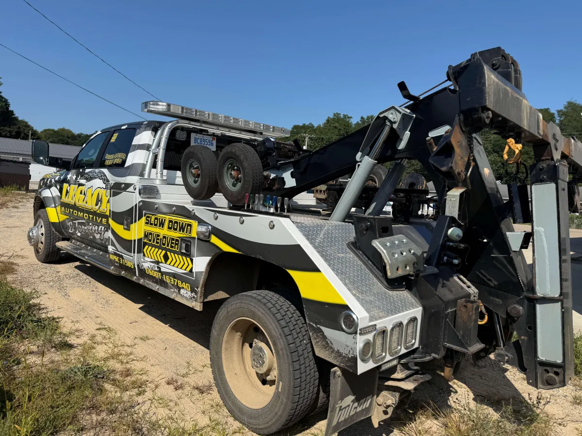 Legacy Automotive tow truck parked on a dirt road after performing an off-road vehicle recovery in Hastings, MI