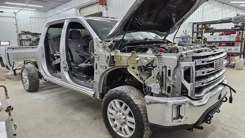 Truck cab with severe structural damage undergoing collision assessment at Legacy Automotive in Hastings, MI