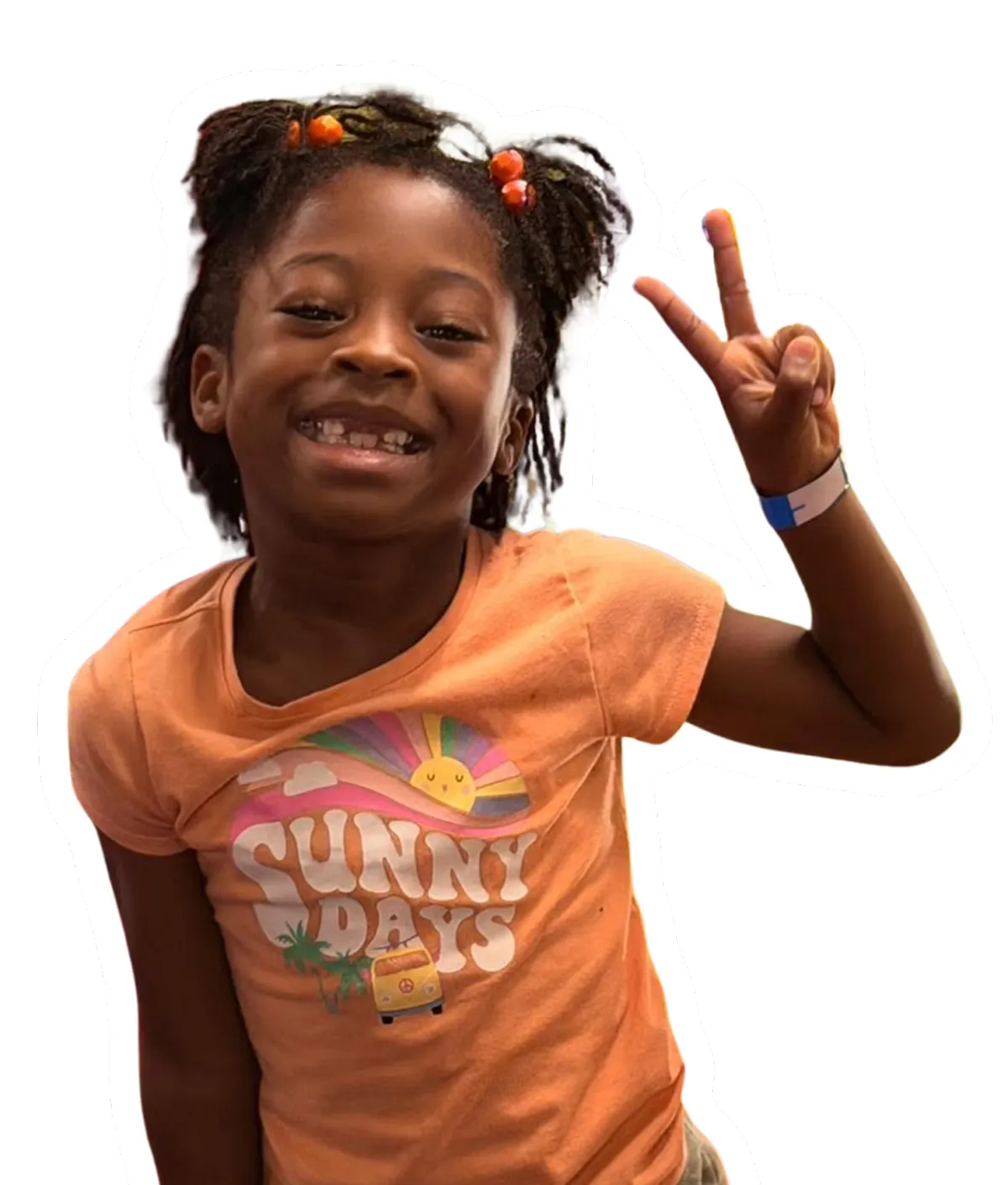 Smiling child with beaded braids raises two fingers in a peace sign, wearing an orange shirt that says “SUNNY DAYS.”