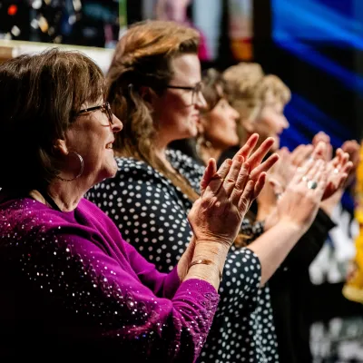 woman in white dress shirt holding yellow book