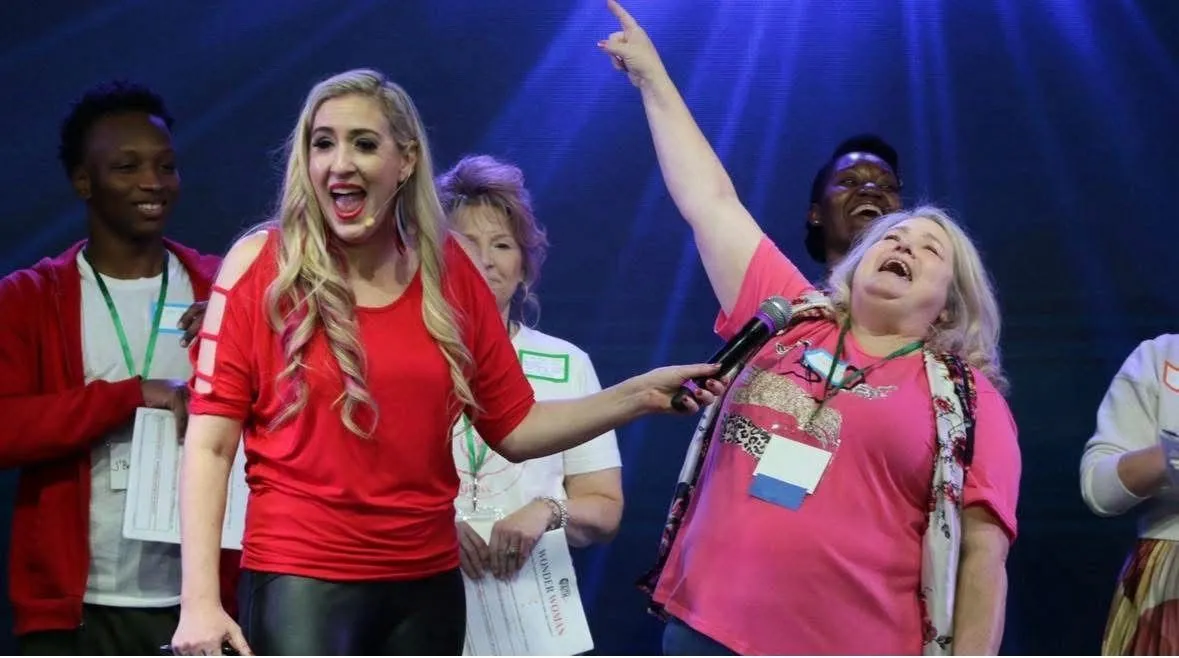 a person holding a sign that says new empowering stories
