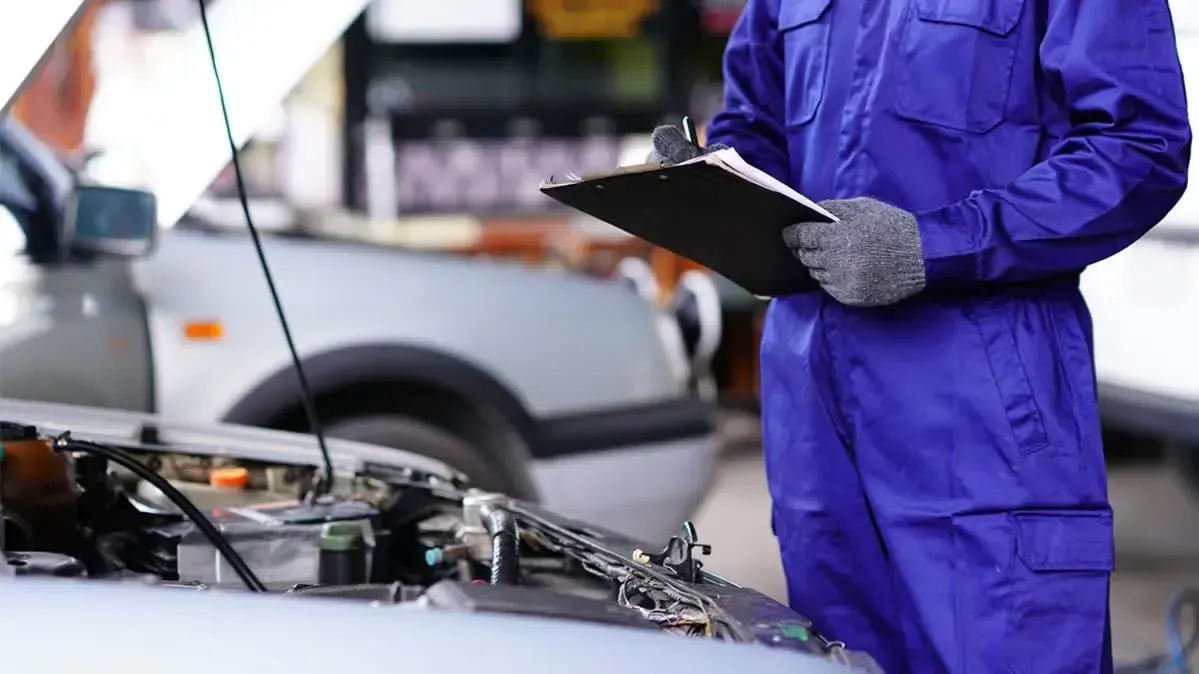 a man working on an engine in a garage
