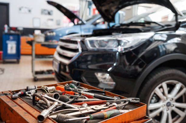 Mechanic working on a car engine in a workshop.