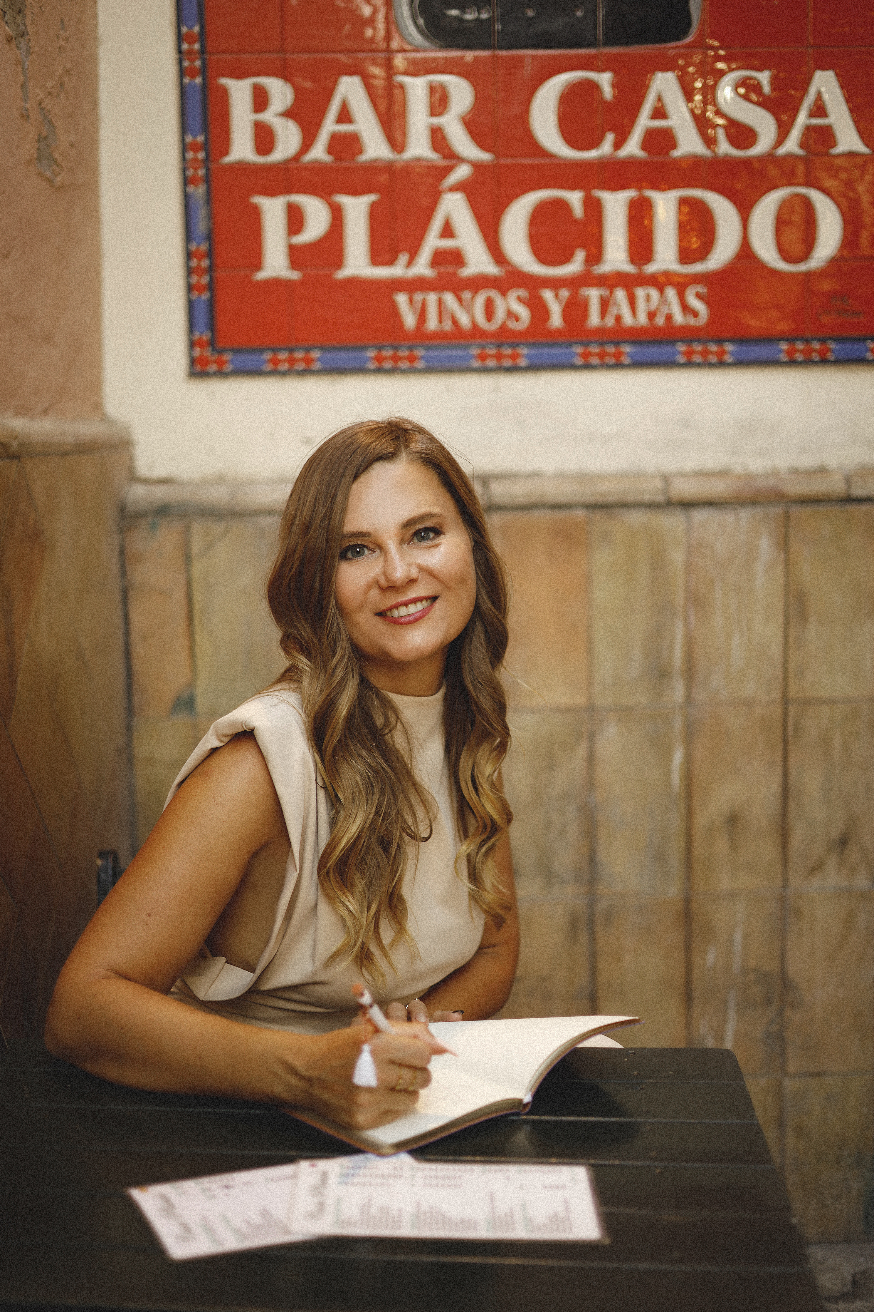 Eva Alexandre writing in a notebook during a strategy session for established consultants seeking business realignment.