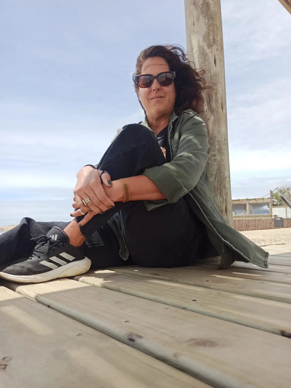 person doing heart shape hand with sun light passing thru