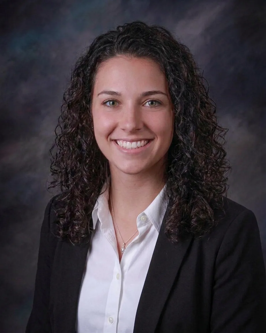 man topless standing on top of hill with dried grass field