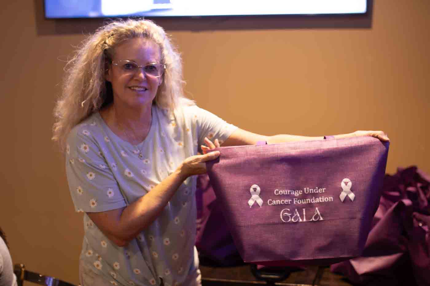 Person on mountain with arms raised