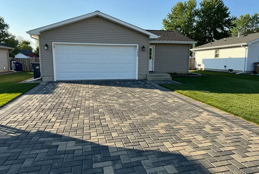 Newly installed charcoal and tan paver driveway leading to a garage in Taylor, Michigan.