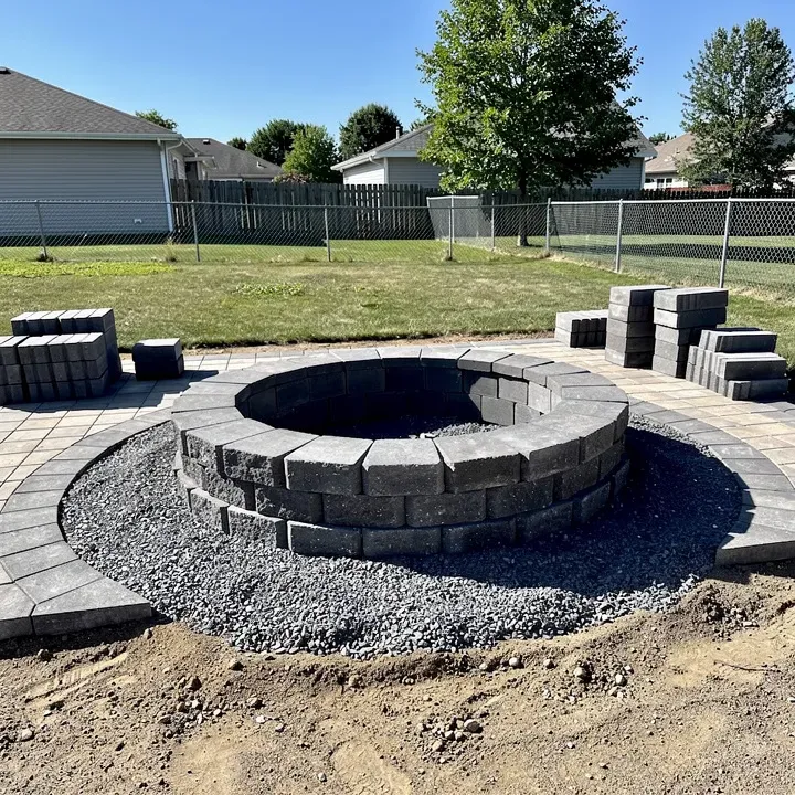 Fire pit installation in progress on a patio in a backyard in Taylor, Michigan.