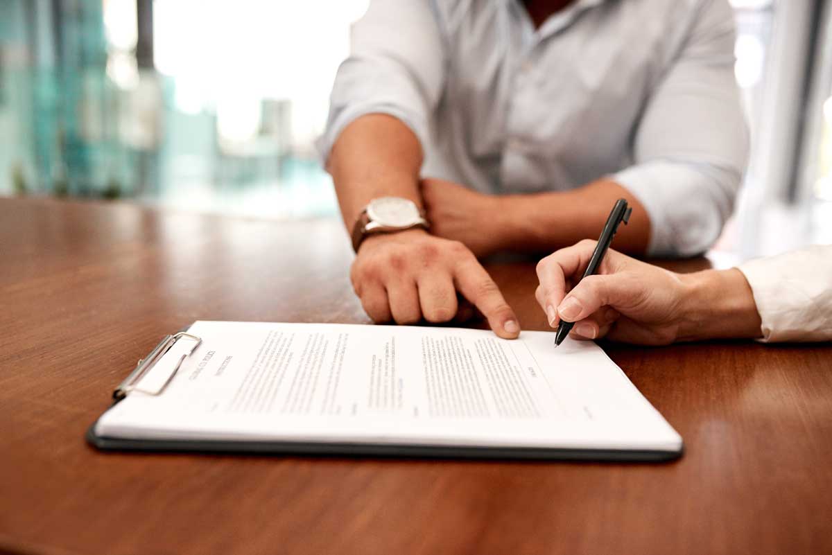 Professional notary closing a mortgage transaction with digital signatures