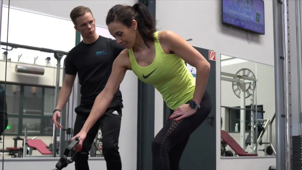 man carrying barbell at the gym