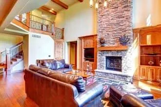 Natural stone fireplace and hearth in family room with vaulted ceilings