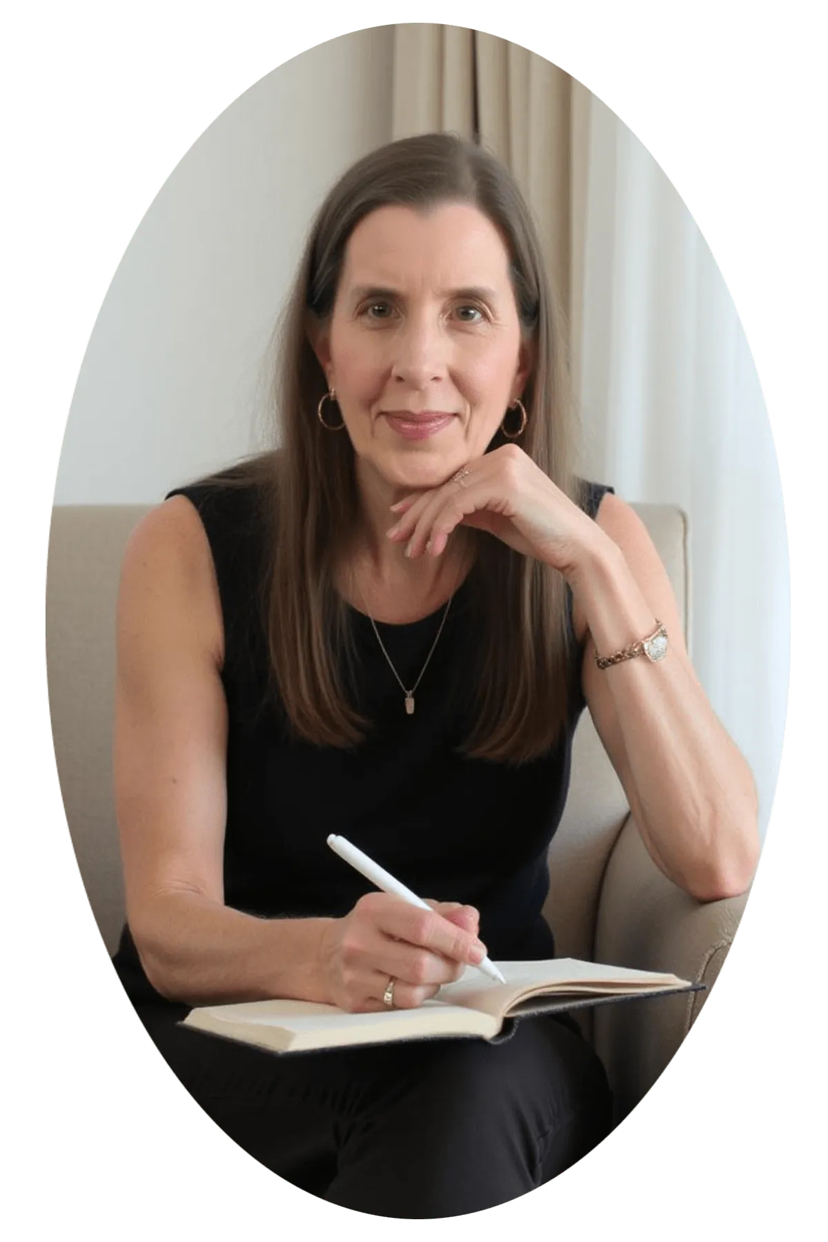 Photo of Mavery Ellscott sitting in a chair wearing a black sleeveless top and black pants.