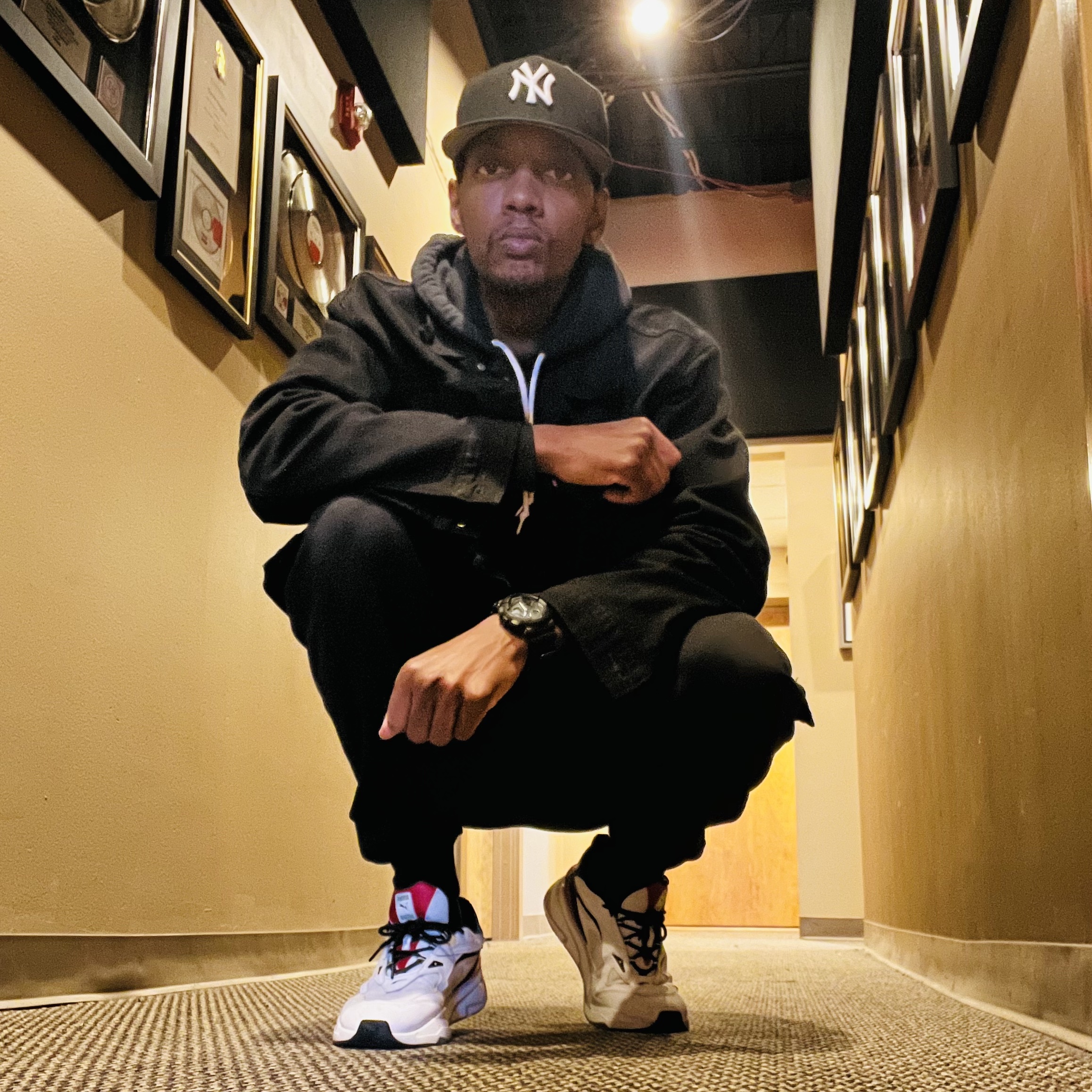 Photo of Hustle Emcee in studio hallway