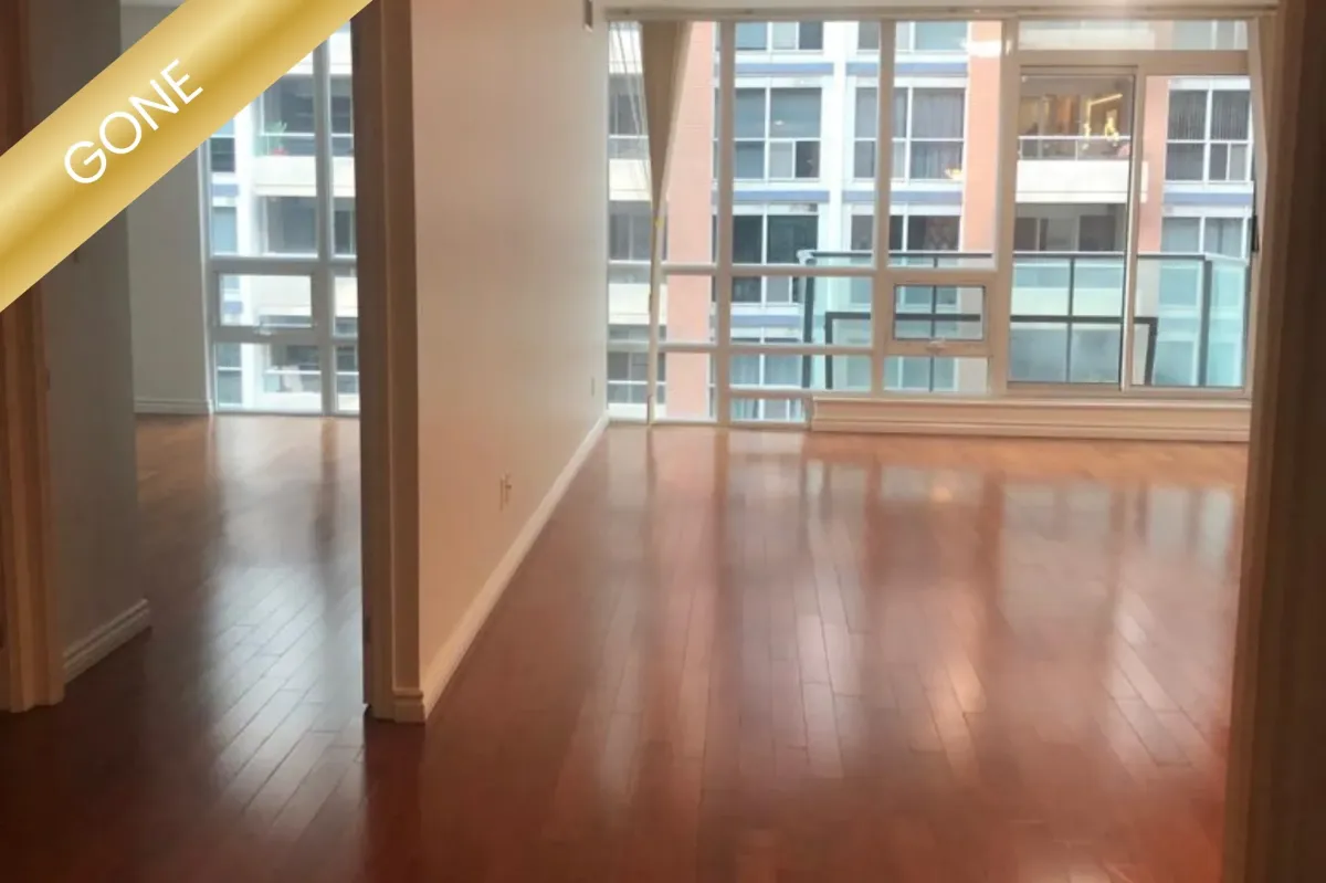 Modern residential condo interior at 263 Wellington St W #701, Toronto, featuring an open concept living area and updated kitchen.