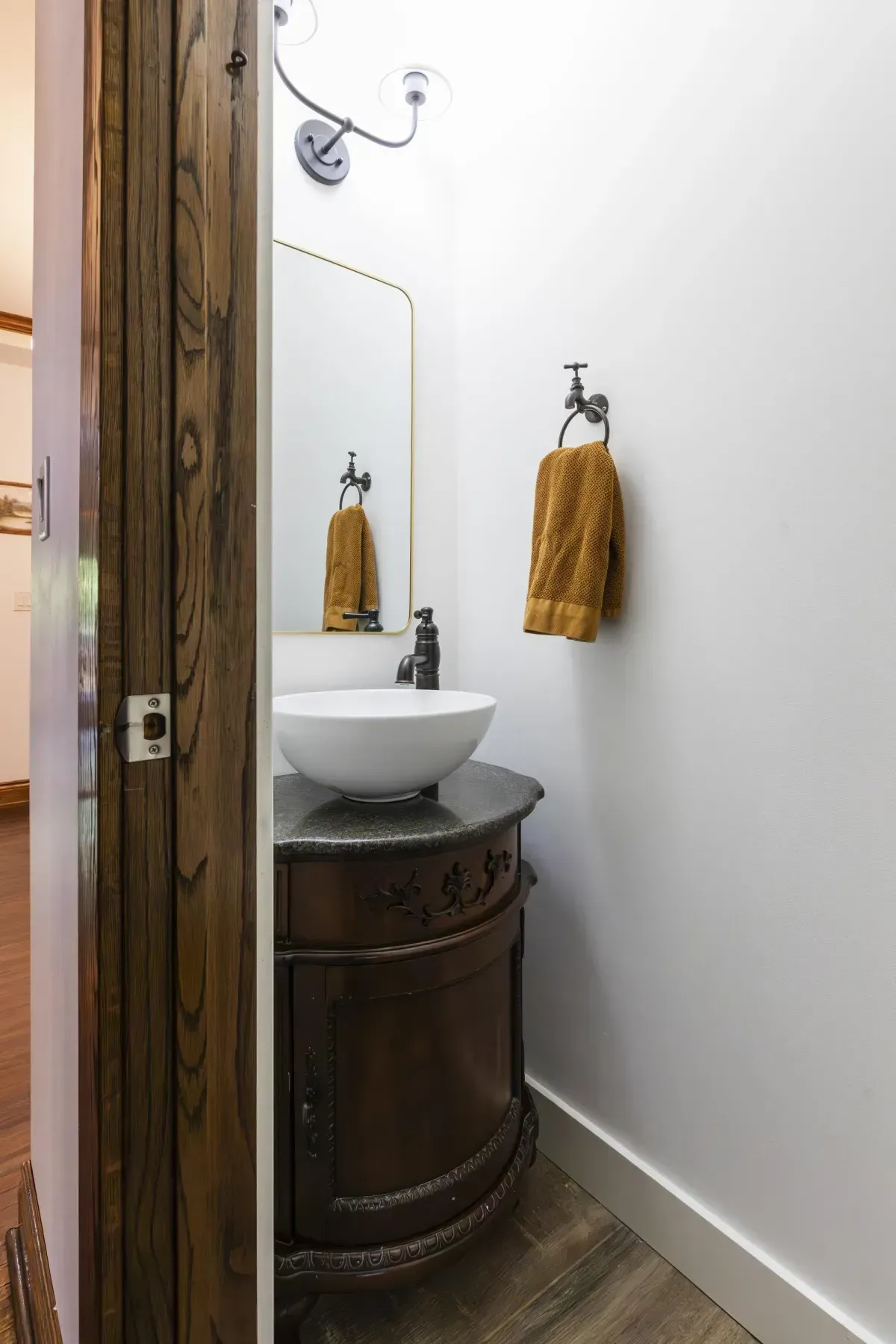 Front living room at 109 Fairleigh Ave S Hamilton featuring restored original hardwood floors, gas fireplace, with natural light.