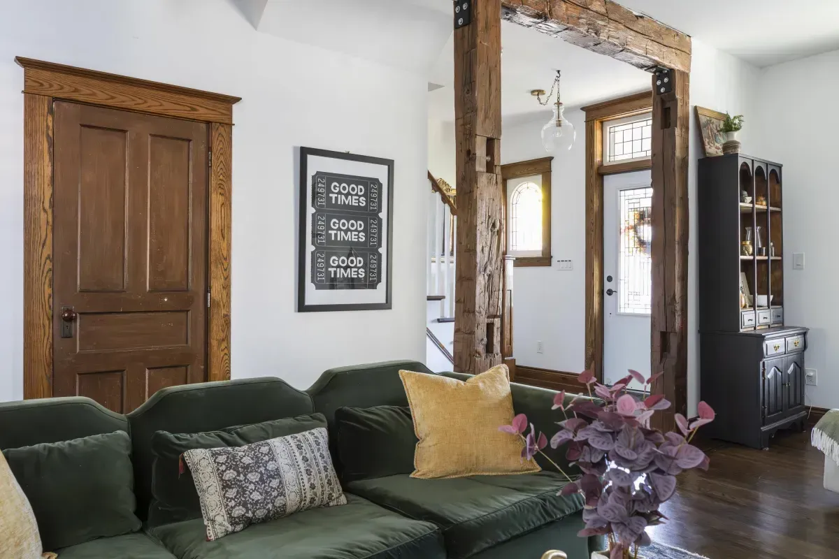 Front living room at 109 Fairleigh Ave S Hamilton featuring restored original hardwood floors, gas fireplace, with natural light.